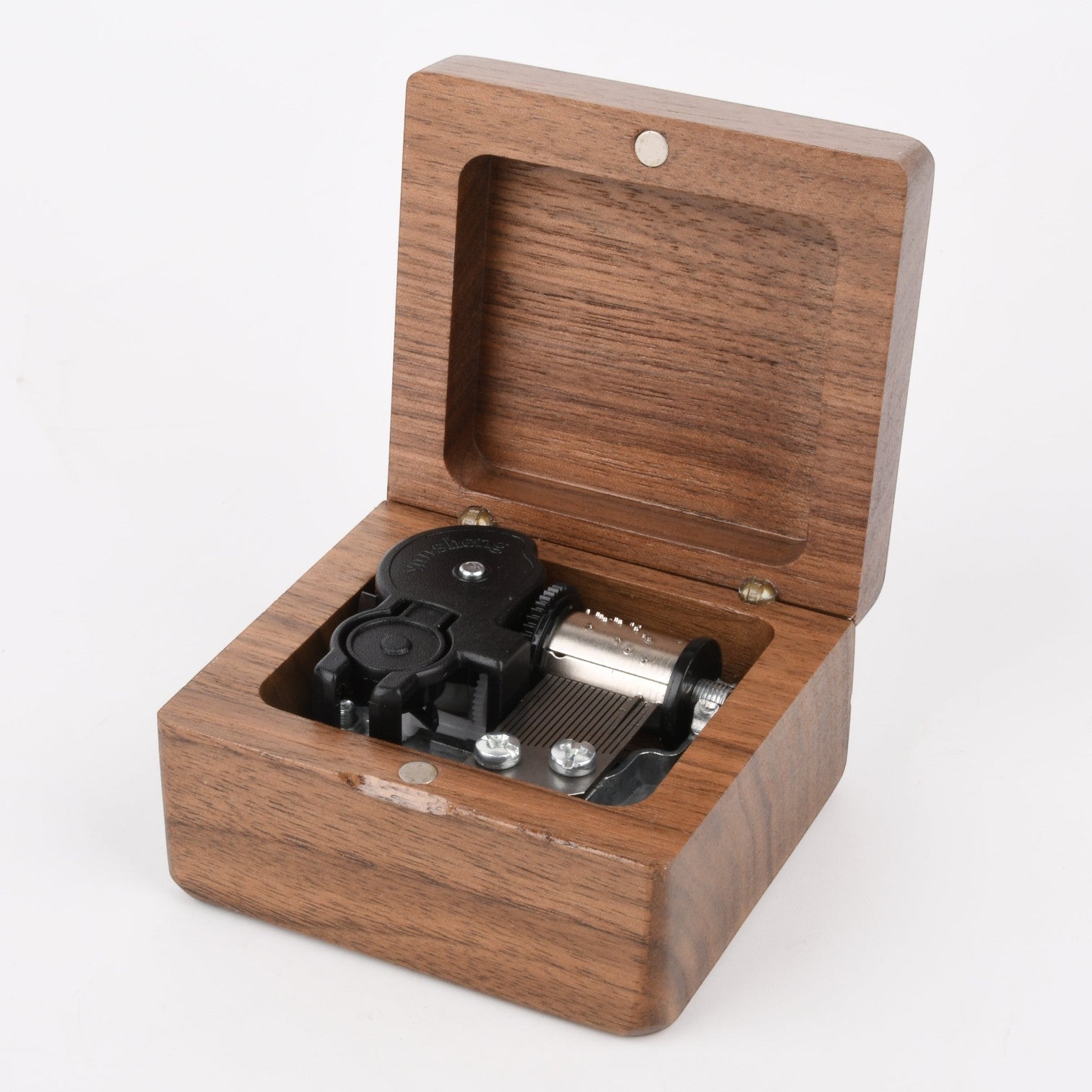 Enchanted Music Boxes square wooden wind-up music box with an open lid revealing the internal metal mechanism.