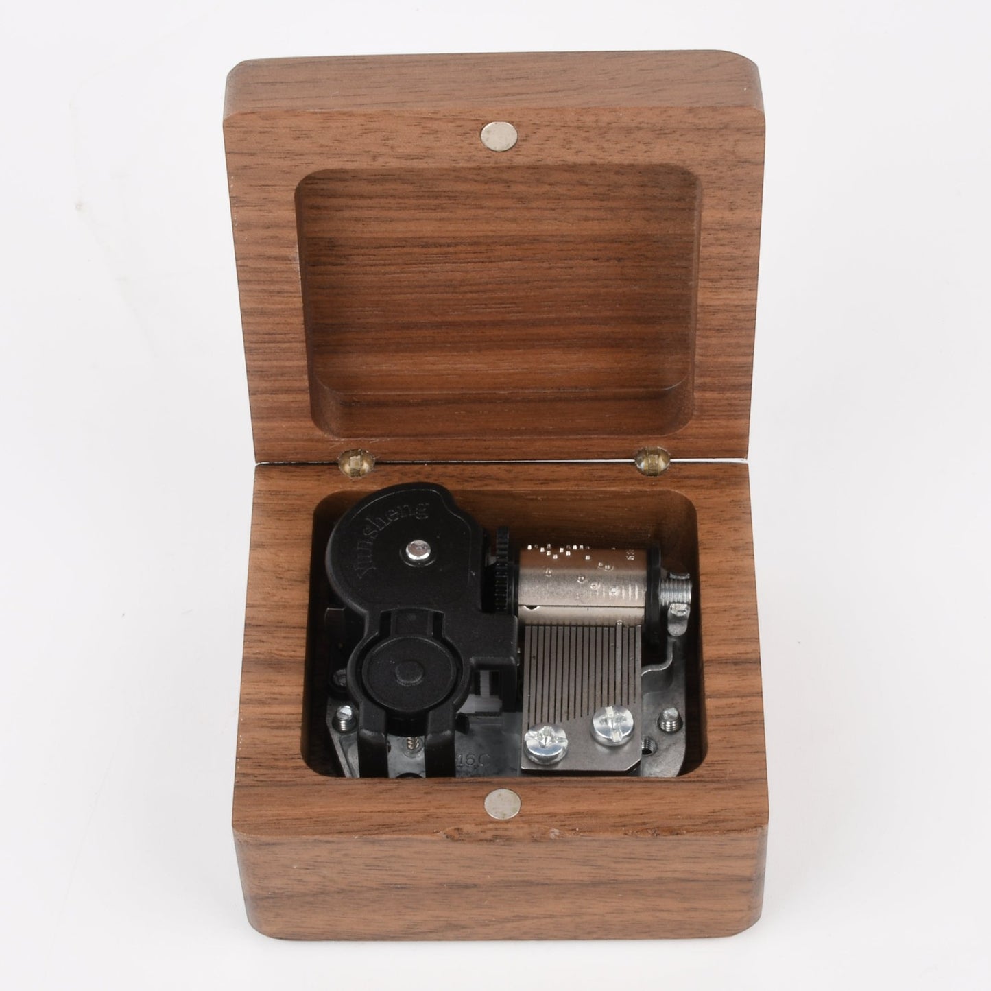 Enchanted Music Boxes square wooden wind-up music box with an open lid revealing the internal metal mechanism.
