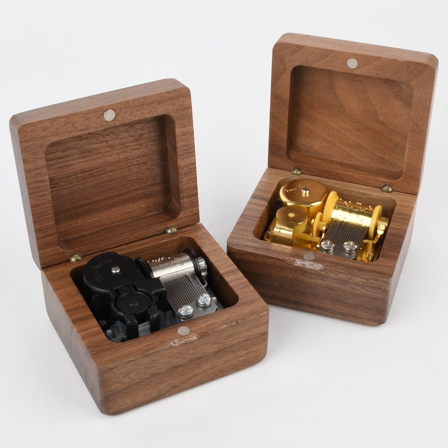 Two Enchanted Music Boxes square wooden wind-up music boxes with open lids revealing internal metal mechanisms
