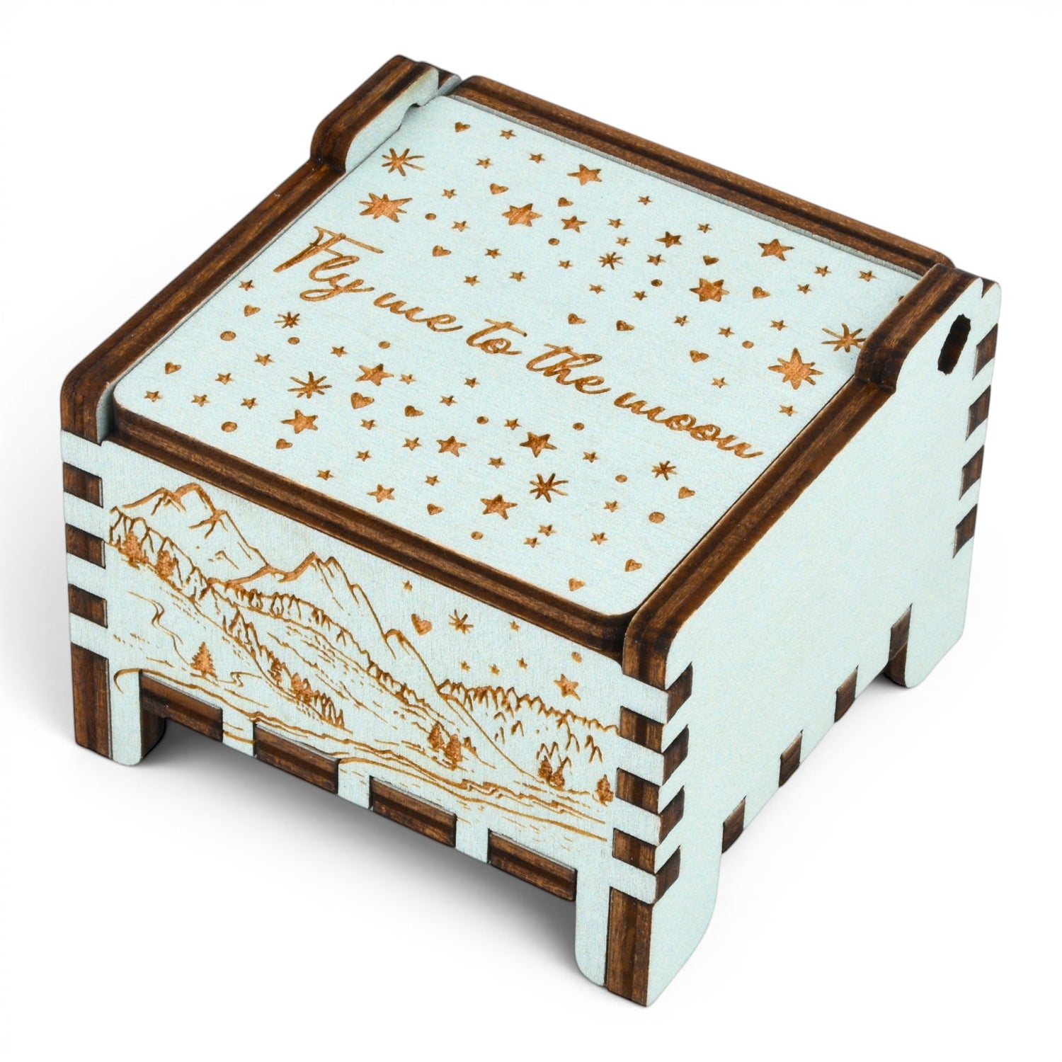 Enchanted Music Boxes teal wooden wind-up music box with engraved starry night sky and alpine mountain landscape.