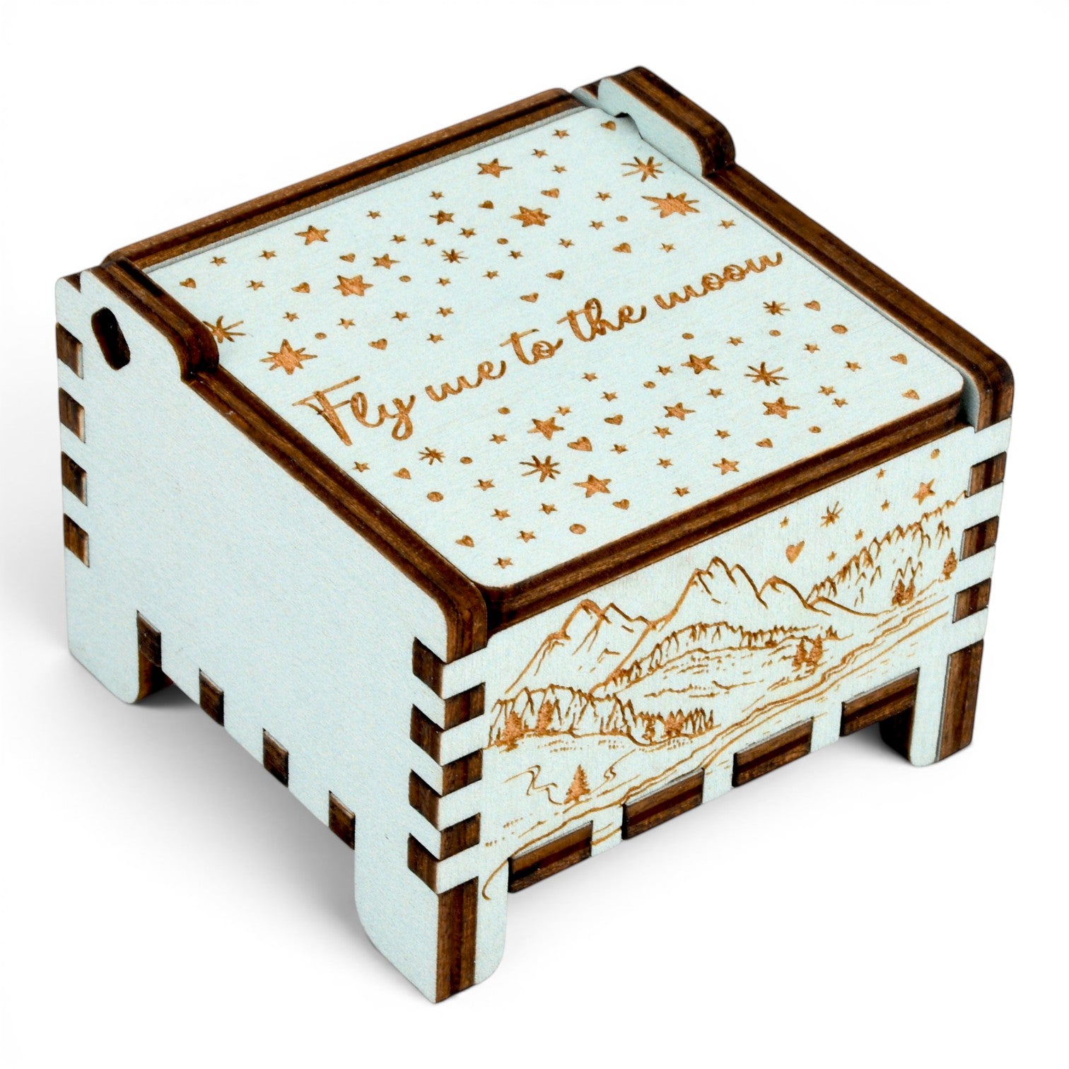 Side view of Enchanted Music Boxes teal wooden wind-up music box with engraved starry night sky and alpine mountain landscape.