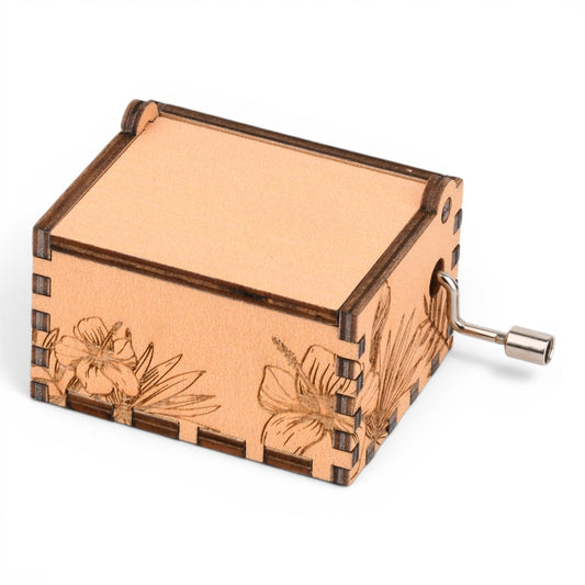 Enchanted Music Boxes tropical plywood music box with laser-engraved hibiscus flowers and a metal hand-crank.