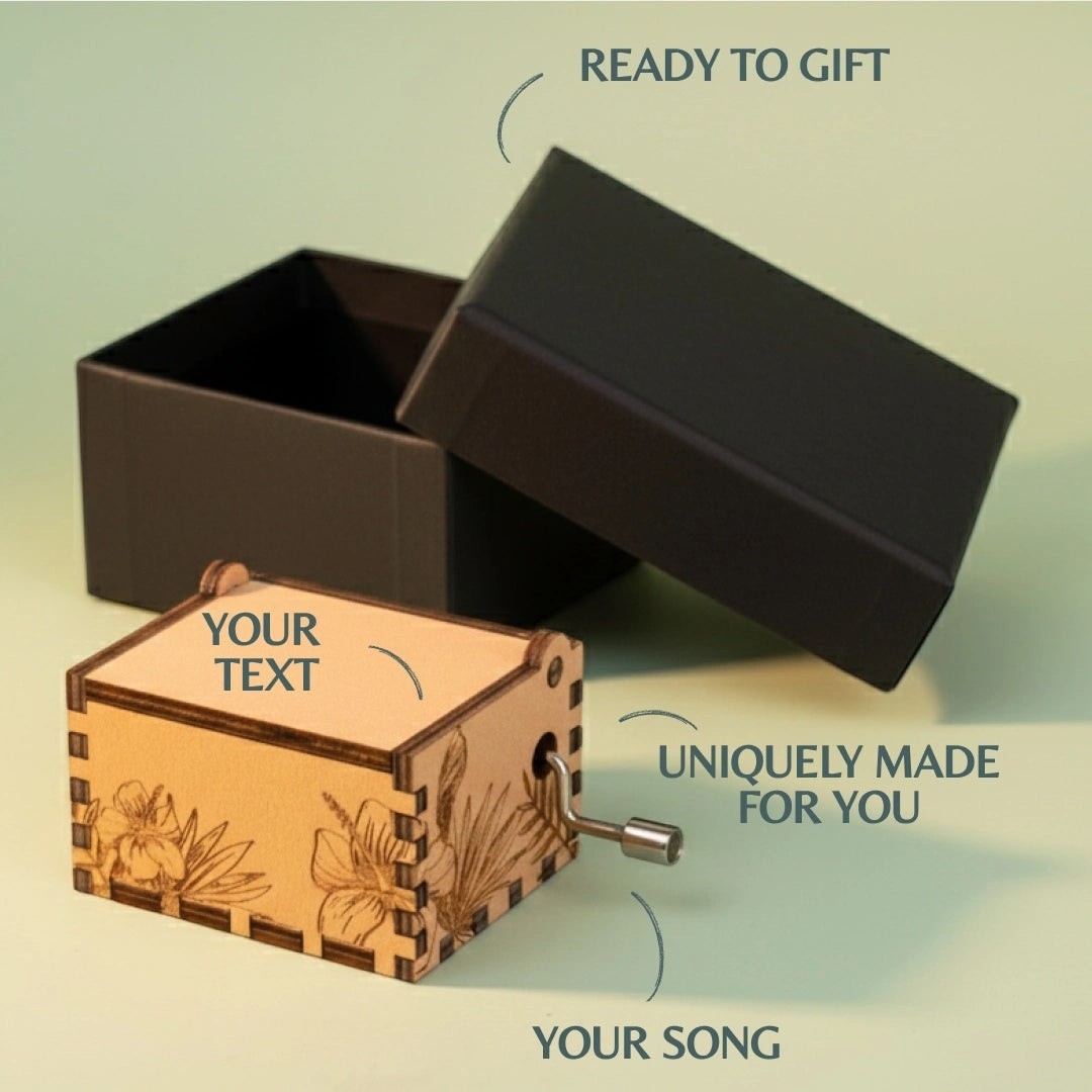 Enchanted Music Boxes tropical plywood hand-crank music box with laser-engraved hibiscus flowers and custom text lid.