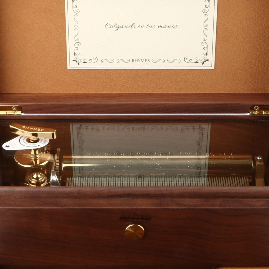 Enchanted Music Boxes 78-note walnut music box with visible gold mechanism and glass panel lid