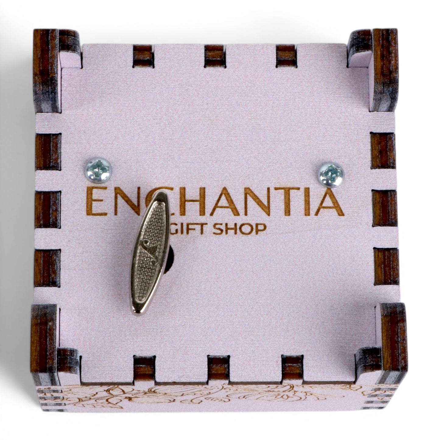 Bottom view of Enchanted Music Boxes wind-up music box with a metal key on a light purple plywood lid featuring engraved details.