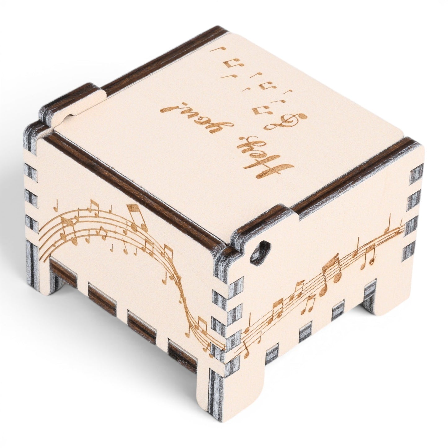Enchanted Music Boxes wooden wind-up music box with laser-engraved musical staves and notes on light plywood panels.